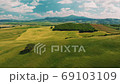 Beautiful and miraculous colors of green spring panorama landscape of Tuscany, Italy. Sunny morning near Pienza. Aerial view  69103109