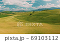 Beautiful and miraculous colors of green spring panorama landscape of Tuscany, Italy. Sunny morning near Pienza. Aerial view  69103112