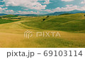 Beautiful and miraculous colors of green spring panorama landscape of Tuscany, Italy. Sunny morning near Pienza. Aerial view  69103114