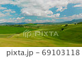 Beautiful and miraculous colors of green spring panorama landscape of Tuscany, Italy. Sunny morning near Pienza. Aerial view  69103118
