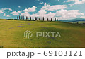 Beautiful and miraculous colors of green spring panorama landscape of Tuscany, Italy. Sunny morning near Pienza. Aerial view  69103121