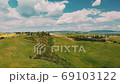 Beautiful and miraculous colors of green spring panorama landscape of Tuscany, Italy. Sunny morning near Pienza. Aerial view  69103122
