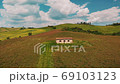 Beautiful and miraculous colors of green spring panorama landscape of Tuscany, Italy. Sunny morning near Pienza. Aerial view  69103123