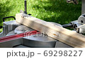 Slow motion. Sawing a wooden panel with a miter saw 69298227