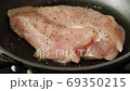 Beginning to bake chicken breast meat slowly in a frying pan 69350215