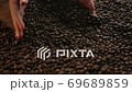 Showing of roasted coffee beans. Female hands raking beans in slow motion 69689859