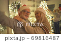 The old couple taking selfie on the christmas tree background. slow motion 69816487