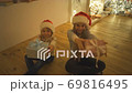 The happy kids with gifts sitting on the floor. slow motion 69816495