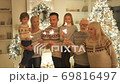 The happy family standing with sparklers near a christmas tree. slow motion 69816497