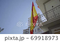 Slow motion gliding shot of Spanish flag waving in the wind 69918973