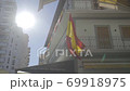 Slow motion glide shot of Spanish flag waving in the wind 69918975