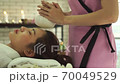 Young beautiful woman doing traditional massage in spa beauty salon 70049529