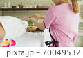 Young beautiful woman doing traditional massage in spa beauty salon 70049532