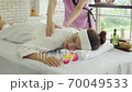 Young beautiful woman doing traditional massage in spa beauty salon 70049533