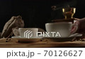 Female hand serves second modern coffee cup. Rotating wood table. Dolly shot 70126627