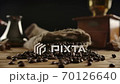 Close up view of scattered roasted dark coffee beans from jute sack. Traditional 70126640