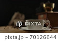 Female hand puts porcelain cup on wooden desk. Serving coffee, hot drinks 70126644