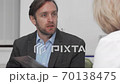 Mature man with headache visiting doctor for prescription 70138475