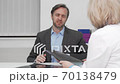 Mature man with joint pain talking to his doctor after x-ray scanning 70138479