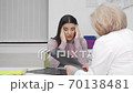 Young woman with terrible headache visiting doctor 70138481