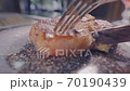 Meat steak is cut with a knife. Piece of meat is lifting up with fork.Tasty food. 70190439