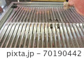 Piece of raw meat is putting on the grill net. Cooking unhealthy food. 70190442