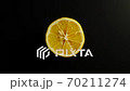 TOP VIEW: Half of lemon rotates on a black surface - Stop motion 70211274