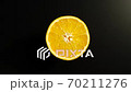 TOP VIEW: Half of an orange rotates on a black surface - Stop motion 70211276
