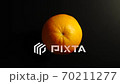 TOP VIEW: Orange rotates on a black surface - Stop motion 70211277