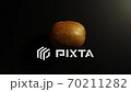TOP VIEW: Kiwi rotates on a black surface - Stop motion 70211282