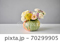 Stop motion, step by step installation of flowers arrangement in pumpkin on the white table. Fresh cut flowers for decoration home. European floral shop. Delivery fresh cut flower. 70299905