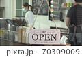 reopen the coffee shop after the quarantine.  young man who owner a retail restaurant is preparing cafe. Barista and the waitress manage sales at counter. 70309009