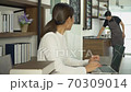 Attractive young Asian woman working on laptop in coffee shop. 70309014