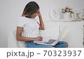 Millennial african ethnic woman student using laptop leaning at home, mixed race disciple distance education typing on notebook 70323937
