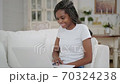 Young african woman student learning by web cam at home. Millennial disciple video conference calling on laptop computer making notes talking by webcam 70324238