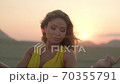 fashion blonde model in yellow clothes posing at sunset in the desert 70355791