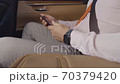 Businessman uses phone in car. Expensive watch on my hand. Leather car interior. 70379420