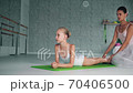 teacher helps preteen ballerina do backbend in