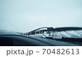 Wipers Clean From Raindrops Car Windshield. In the foreground on the car panel are glasses for vision 70482613
