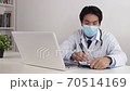 Asian Doctor Wear Face Mask Write Patient Exam Report in Office 70514169