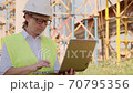Female foreman at construction site working on laptop on background of reinforced concrete structures. 70795356