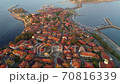 Aerial view of Nesebar old town, Bulgaria. Red tiled roofs of houses in the town of Nesebar. Island where the city is located is washed by the waters of the Black Sea 70816339