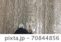 Women's legs while walking on a muddy road 70844856