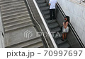 people while climb the metro station stairs wearing protective mask 70997697