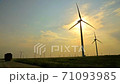 Truck Drives Road with Wind Farm Background 71093985