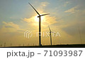 Wind Farm at Sunset on a Cloudy Sky Background 71093987