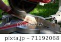 Footage of a circular saw that sawing through a piece of wood 71192068