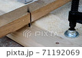 Slow Motion. Sawing a piece of wood with a jigsaw. 71192069