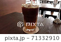 Footage of americano and orange juice mixing by straw in glass. 71332910