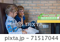 Children eat pizza in the pizzeria 71517044